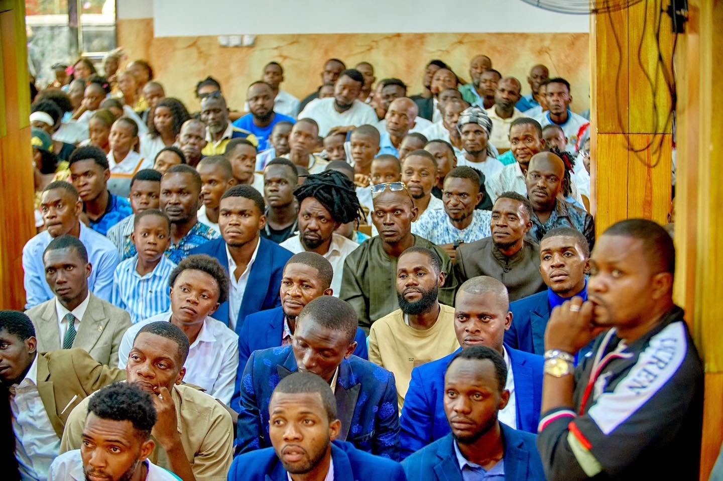 Men of the church seated during a Liloba gathering