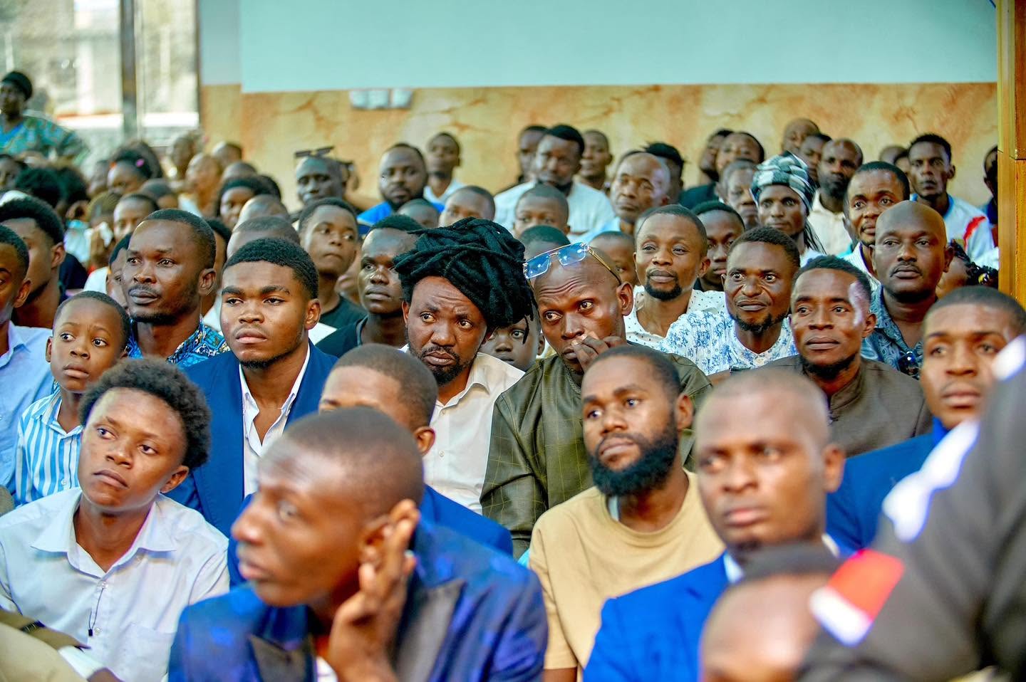 Men of the congregation listening during a Liloba gathering
